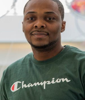 Clement Essien poses outside Bond LSC near the building’s garden.